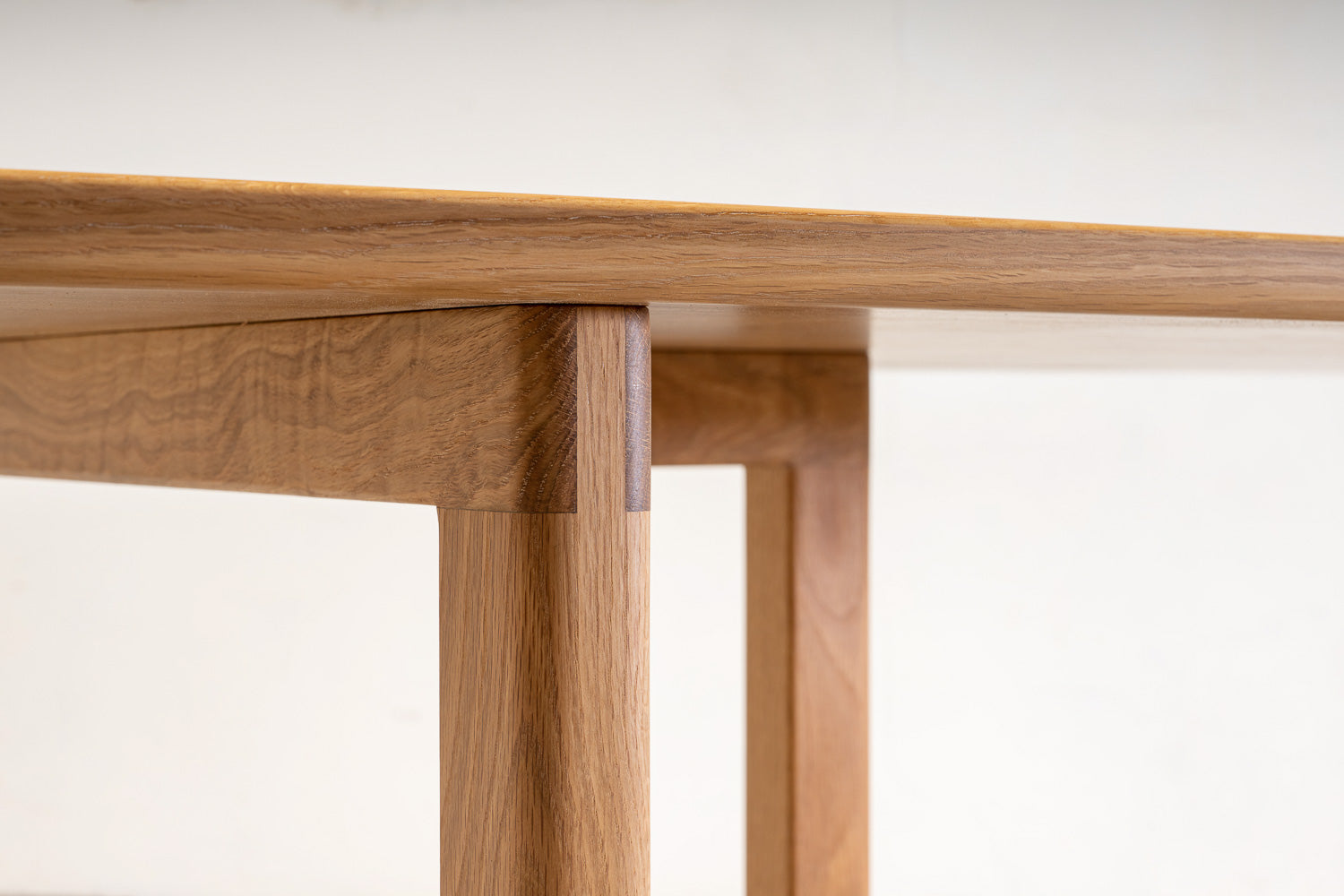 The Mikal DiningTable in White Oak - detail view of bridle joint. Designed and made by Hey, Porter.