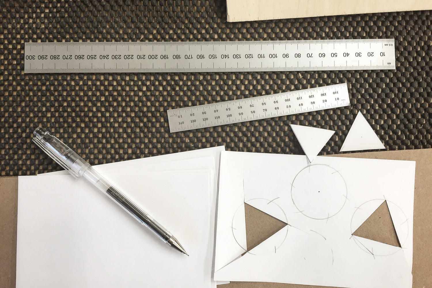 Pen and rulers with paper cut outs — part of the design process